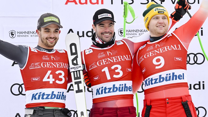 epa10418072 Winner Vincent Kriechmayr of Austria, center, poses on the podium with second placed Florian Schieder of Italy, left, and third placed Niels Hintermann of Switzerland, right, after the men ...