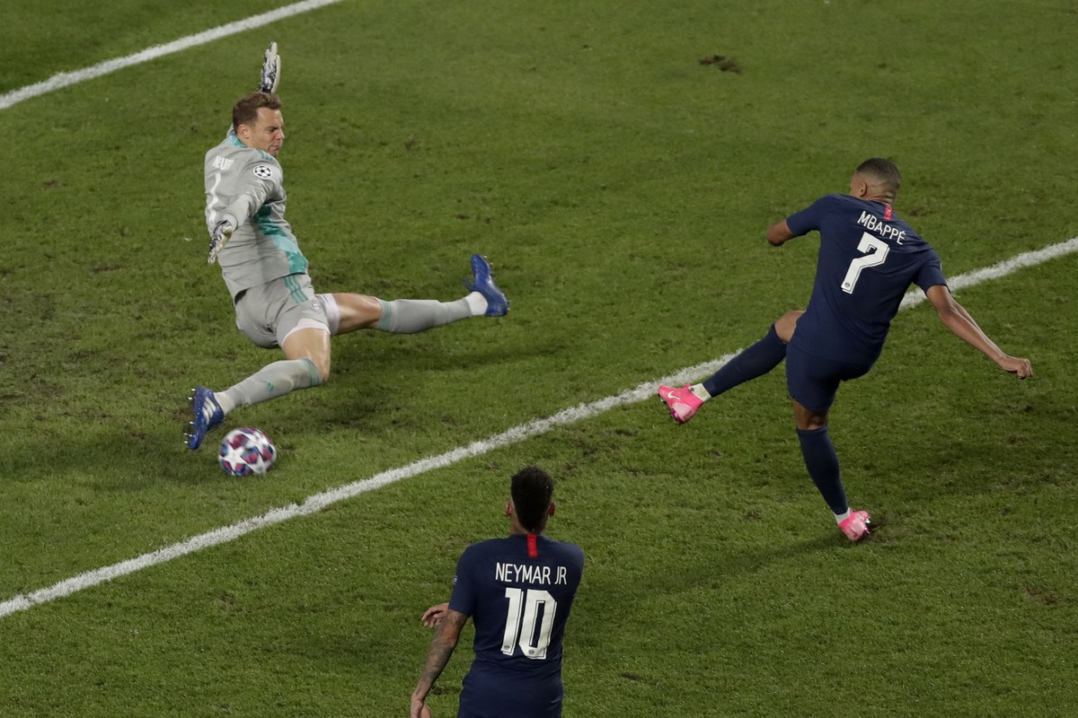 Bayern's goalkeeper Manuel Neuer saves a shot by PSG's Kylian Mbappe during the Champions League final soccer match between Paris Saint-Germain and Bayern Munich at the Luz stadium in Lisbon ...