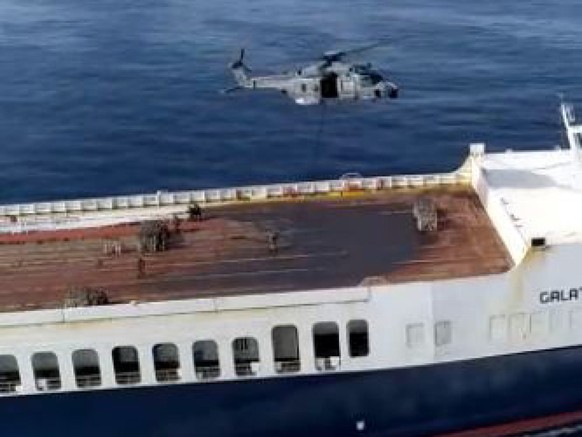epa10682518 A handout photo made available by Italian Defense, shows the Italian military about to land on the merchant ship Galata Seaways, Naples, Italy, 09 June 2023. The attempted seizure by armed ...