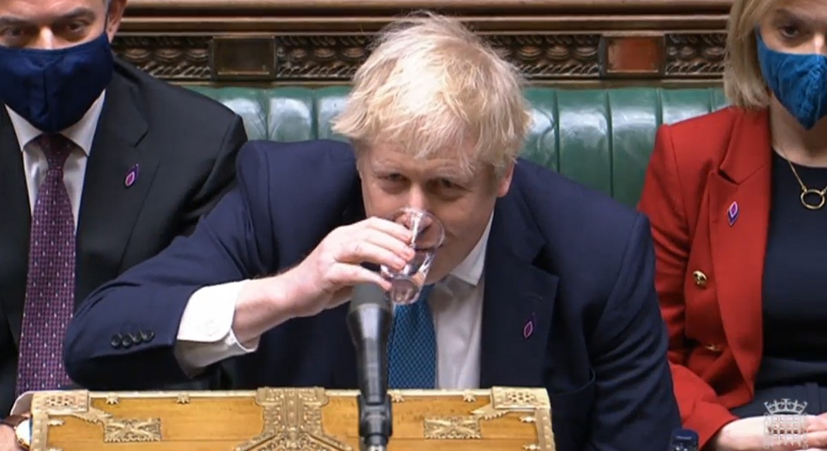 epa09710299 A grab from a handout video released by the UK Parliament shows opposition British Prime Minister Boris Johnson taking a sip of water during the Prime Minister's Questions (PMQs) at t ...