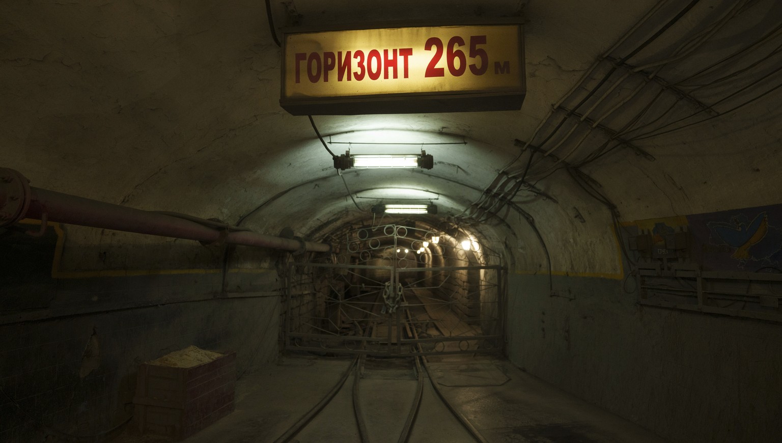 A sign reading &quot;horizon 265 meters underground&quot; hangs in the tunnel of a coal mine in Dnipropetrovsk region, Ukraine, Jan. 30, 2025. (AP Photo/Evgeniy Maloletka)
Russia Ukraine War Women Wor ...