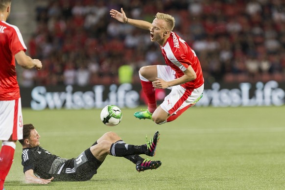 Belarus&#039; Aliaksandr Paulavets, left, fights for the ball with Swiss defender Florent Hadergjonaj, right, during a friendly soccer match on the side line of the 2018 Fifa World Cup group B qualifi ...