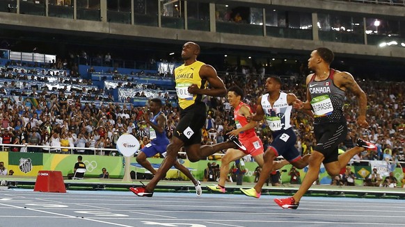 2016 Rio Olympics - Athletics - Semifinal - Men's 100m Semifinals - Olympic Stadium - Rio de Janeiro, Brazil - 14/08/2016. Usain Bolt (JAM) of Jamaica (C) leads. REUTERS/Kai Pfaffenbach FOR EDITORIAL  ...