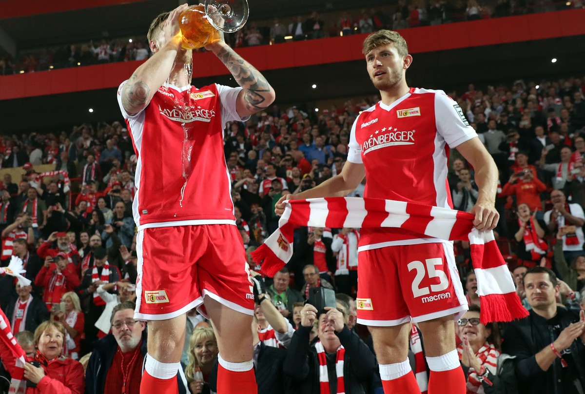epa07606714 Union's Sebastian Polter (L) and Christopher Lenz celebrate after winning the German Bundesliga relegation play-off second leg soccer match between FC Union Berlin and VfB Stuttgart,  ...