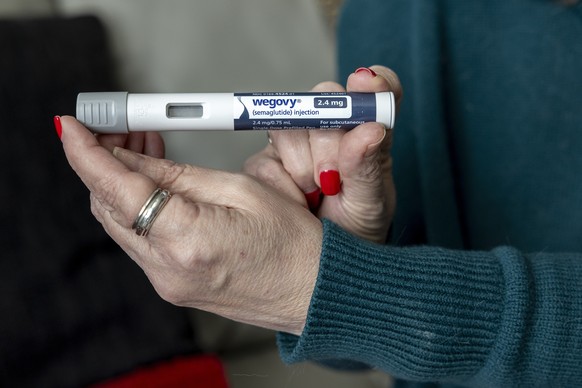 FILE - Donna Cooper holds up a dosage of Wegovy, a drug used for weight loss, at her home in Front Royal, Va., on Friday, March 1, 2024. (AP Photo/Amanda Andrade-Rhoades, File)
Donna Cooper