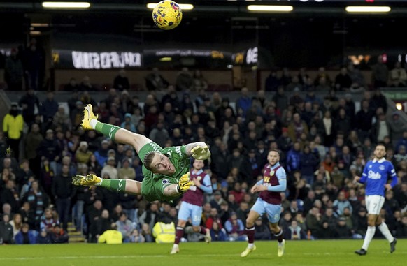 Everton goalkeeper Jordan Pickford makes a save, during the English Premier League soccer match between Burnley and Everton at Turf Moor, Burnley, England, Saturday Dec. 16, 2023. (Nick Potts/PA via A ...