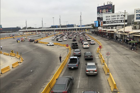 Cars wait in line to enter the United States at San Diego&#039;s San Ysidro border crossing, Tuesday, Aug. 25, 2020, in Tijuana, Mexico. A Trump administration crackdown on nonessential travel coming  ...