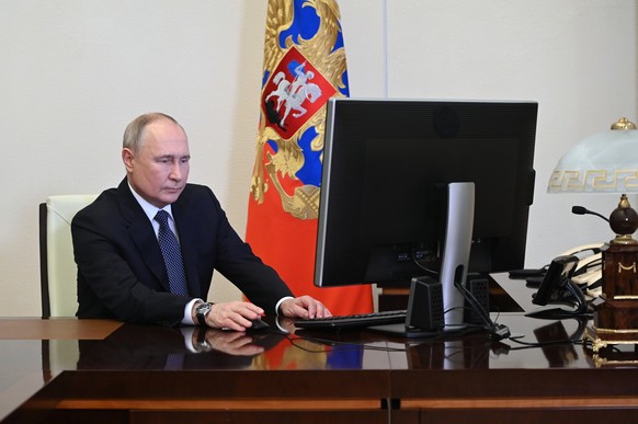 epa11222921 Russian President Vladimir Putin votes online during the presidential elections at the Novo-Ogaryovo state residence, outside Moscow, Russia, 15 March 2024. Voting will last three days: Ma ...