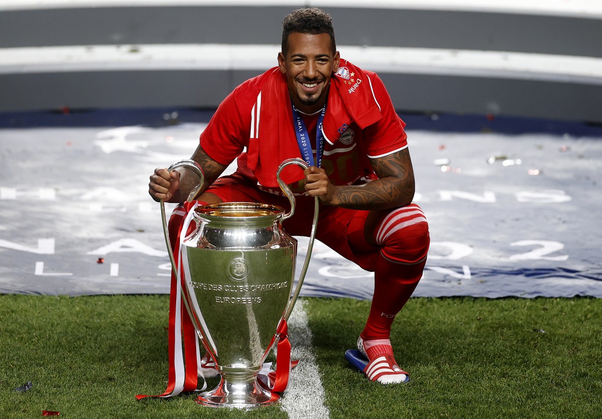 Bayern's Jerome Boateng celebrates with the trophy after Munich won the Champions League final soccer match between Paris Saint-Germain and Bayern Munich at the Luz stadium in Lisbon, Portugal, S ...