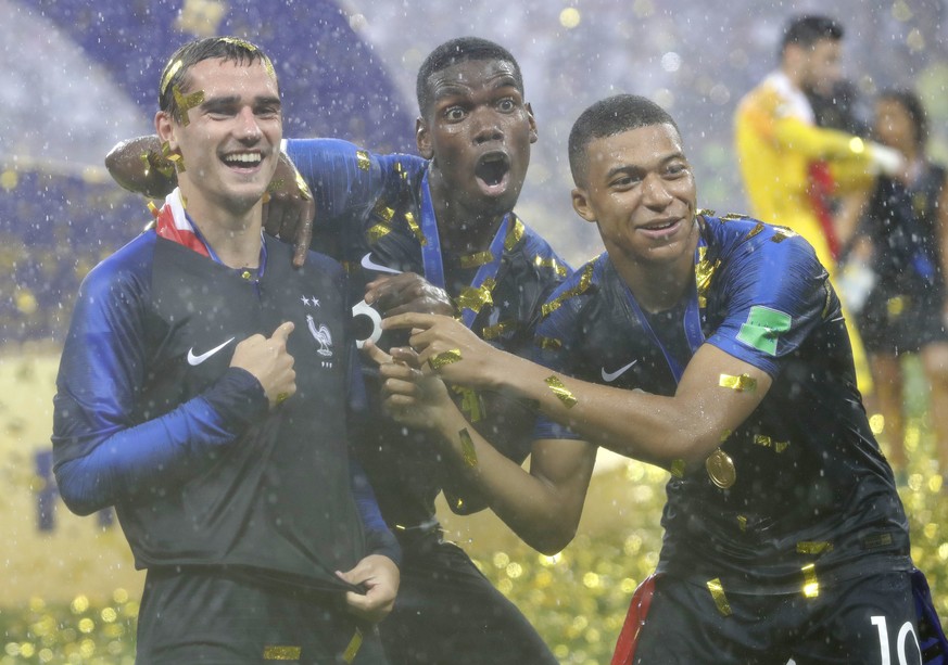 France&#039;s Antoine Griezmann, points to two stars on his jersey indicating two world cup wins, as he celebrates with Paul Pogba and Kylian Mbappe after the final match between France and Croatia at ...