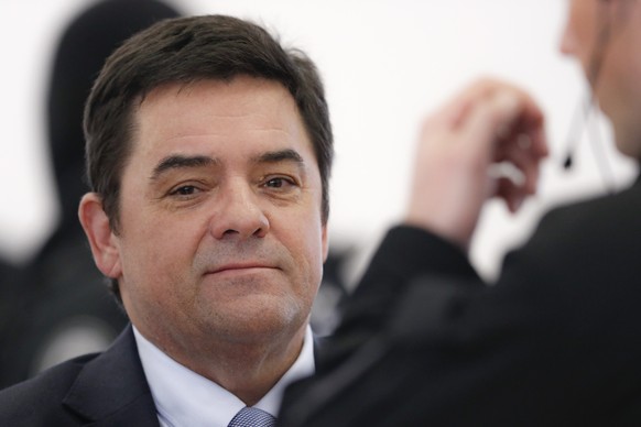 FILE - Marian Kocner, the suspected mastermind behind the murder of investigative journalist Jan Kuciak and his fiancé Martina Kusnirova, is escorted from a courtroom by armed police after a…