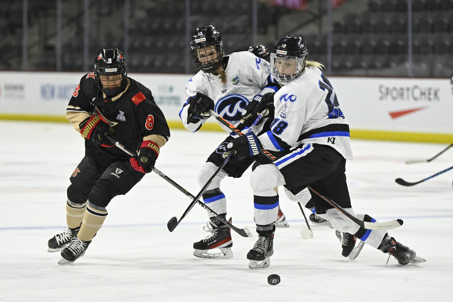 TEMPE, AZ - MARCH 26: Toronto Six forward Leah Lum 8 and Minnesota Whitecaps forward Stephanie Anderson 18 eye a loose puck during the Isobel Cup Final between the Minnesota Whitecaps and Toronto Six  ...