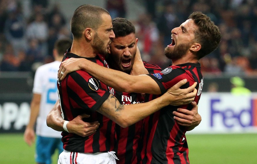 AC Milan&#039;s Matteo Musacchio, center, celebrates with his teammates Leonardo Bonucci, left, and Fabio Borini Bonucci after scoring during the Europa League group D soccer match between AC Milan an ...