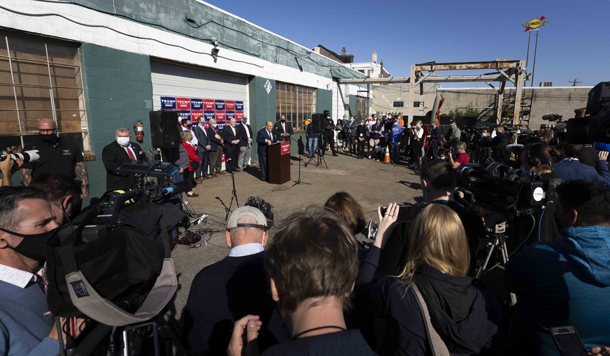 epa08806162 Trump lawyer Rudy Giuliani gives a press conference at a podium set up in the parking lot of a landscaping company after Joe Biden was declared as winner of the 2020 Presidential Election  ...