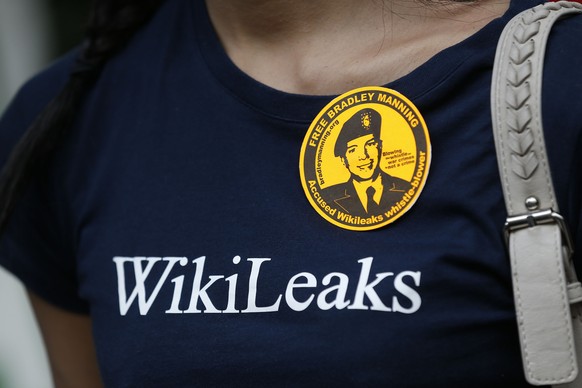 FILE - In this Wednesday, Aug. 21, 2013 file photo, a supporter of WikiLeaks protests outside the U.S. Embassy in London. WikiLeaks has published documents it says shows the U.S. National Security Age ...