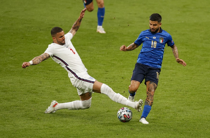 England&#039;s Kyle Walker, left, and Italy&#039;s Lorenzo Insigne battle for the ball during the Euro 2020 soccer championship final between England and Italy at Wembley stadium in London, Sunday, Ju ...