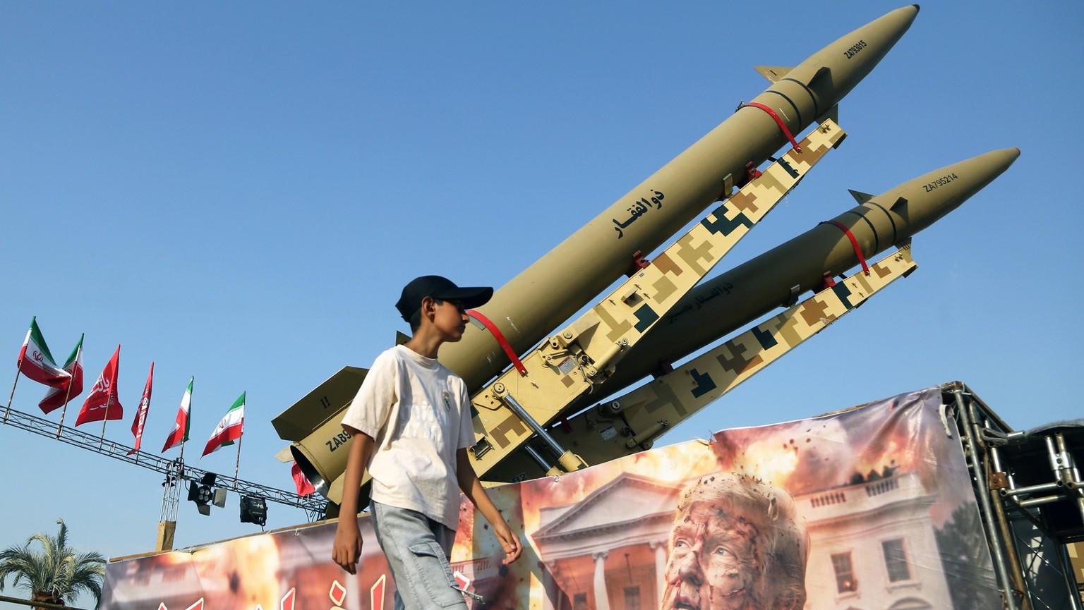 Trump-targeting banner displayed in Tehran s Azadi Square TEHRAN, IRAN - AUGUST 2: A boy walks in front of a banner depicting U.S. President Donald Trump and bearing messages was displayed in front of ...