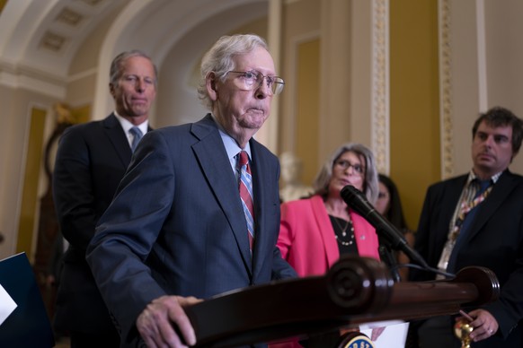 Senate Minority Leader Mitch McConnell, R-Ky., joined at left by Sen. John Thune, R-S.D., and Sen. Joni Ernst, R-Iowa, seems to freeze at the microphones as he arrived for a news conference at the Cap ...
