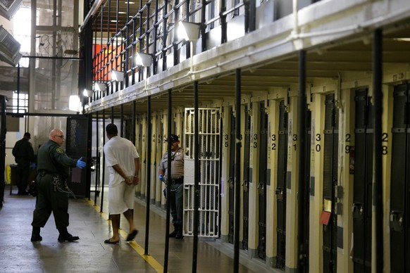 FILE - In this Aug. 16, 2016, file photo a condemned inmate is led out of his east block cell on death row at San Quentin State Prison, in San Quentin, Calif. Gov. Gavin Newsom is expected to sign a m ...