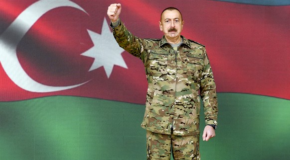 In this handout photo provided by the Azerbaijan's Presidential Press Office provided on Sunday, Nov. 8, 2020, Azerbaijani President Ilham Aliyev gestures as he addresses the nation in Baku, Azer ...