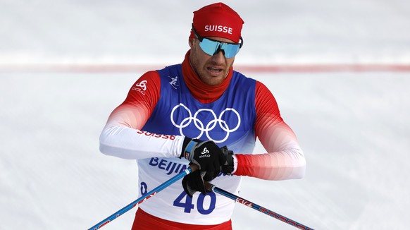 Dario Cologna of Switzerland reacts in the finish area during the men's 15km classic cross-country skiing competition at the 2022 Winter Olympics in Zhangjiakou, China, on Friday, Feb. 11, 2022.  ...