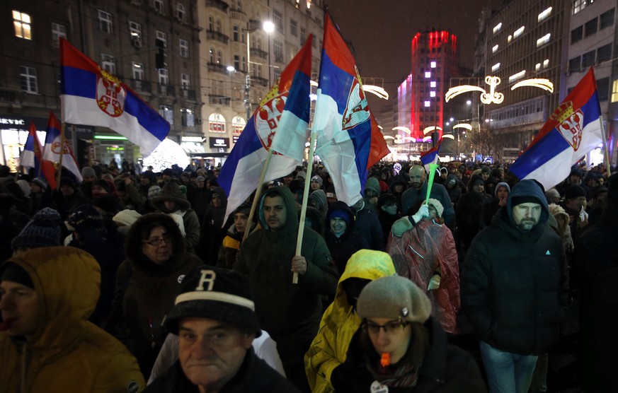 People march during a protest against populist President Aleksandar Vucic in Belgrade, Serbia, Saturday, Jan. 5, 2019. Thousands of people have protested in Serbia for a fifth consecutive week over wh ...