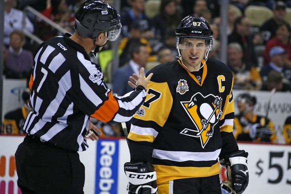 FILE - In this Feb. 19, 2017 file photo Pittsburgh Penguins&#039; Sidney Crosby (87) listens to referee Garrett Rank (7) during the second period of an NHL hockey game against the Detroit Red Wings in ...