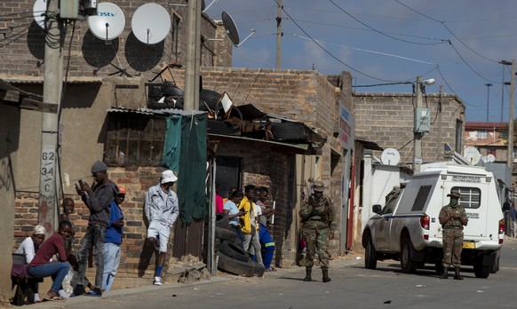 South African National Defence Forces, patrol the street of a densely populated Alexandra township in Johannesburg, South Africa, Thursday, April 16, 2020. South African President Cyril Ramaphosa extended the lockdown by an extra two weeks in a continuing effort to contain the spread of COVID-19. (AP Photo/Themba Hadebe)