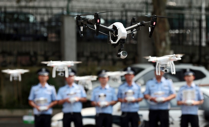 epa04850119 An archive picture made available on 17 July 2015 of of policemen practicing controlling drones after the establishment ceremony of the first police drone squad in Nanjing, Jiangsu provinc ...