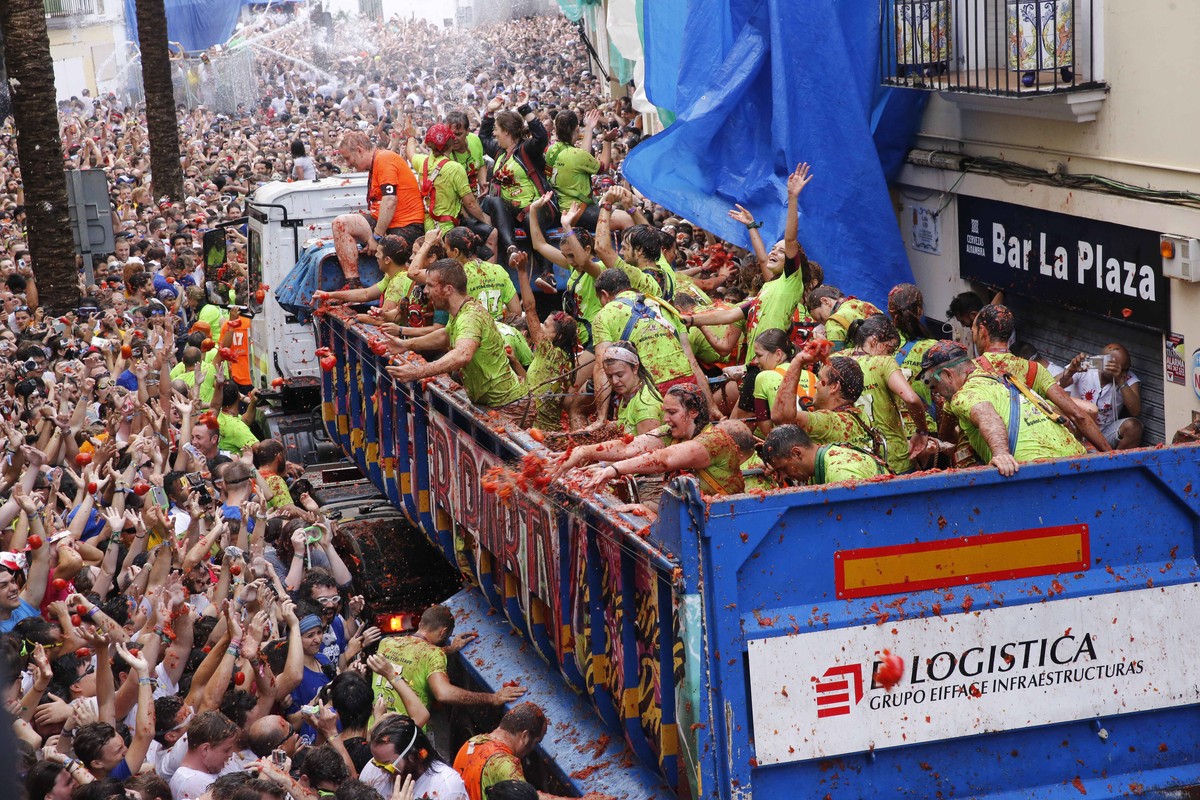 Crowds of people throw tomatoes at each other, during the annual "tomatina" tomato fight fiesta in the village of Bunol, 50 kilometers outside Valencia, Spain, Wednesday, Aug. 30, 2017. (AP  ...