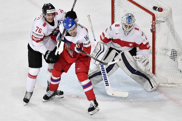 Switzerland’s Joel Genazzi, left, and Switzerland’s goaltender Niklas Schlegel, right, in action against Czech Republic’s Michal Birner during their Ice Hockey World Championship group B preliminary r ...