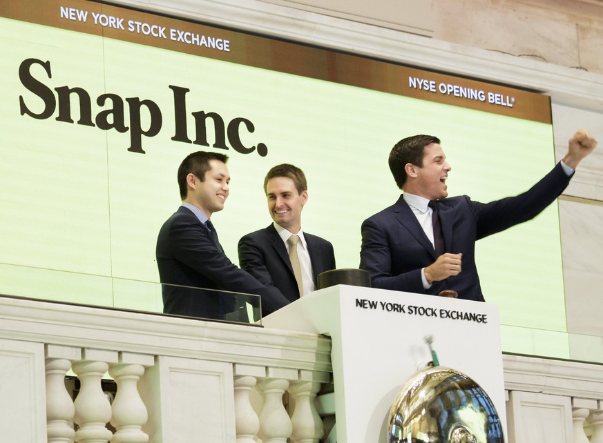 epa05825219 Snapchat co-founders Bobby Murphy (L) and Evan Spiegel (C) ring the opening bell while standing with Thomas W. Farley (R), the President of the NYSE, during the initial public offering of  ...