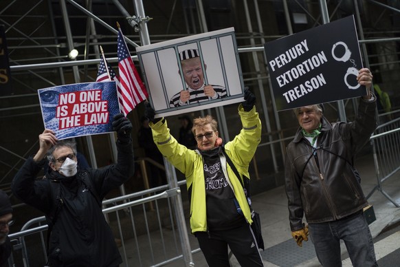 A small group of people protest in front of the district attorney's office ahead of the expected indictment of former President Donald Trump on Friday, March 24, 2023 in New York.  The Manhattan g...