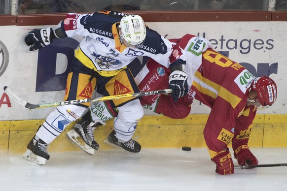 Tigers Thomas Nuessli, rechts, kaempft um den Puck, gegen Zugs David McIntyre, links, waehrend dem Meisterschaftsspiel der National League, zwischen den SCL Tigers und den EV Zug, am Freitag, 15. Sept ...