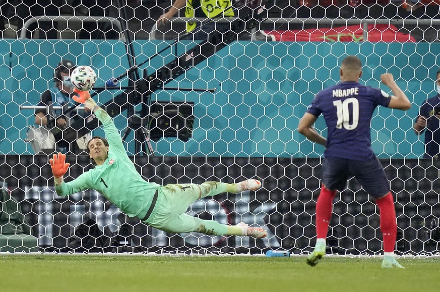 Switzerland's goalkeeper Yann Sommer saves the penalty shot by France's Kylian Mbappe during the Euro 2020 soccer championship round of 16 match between France and Switzerland at the Nationa ...