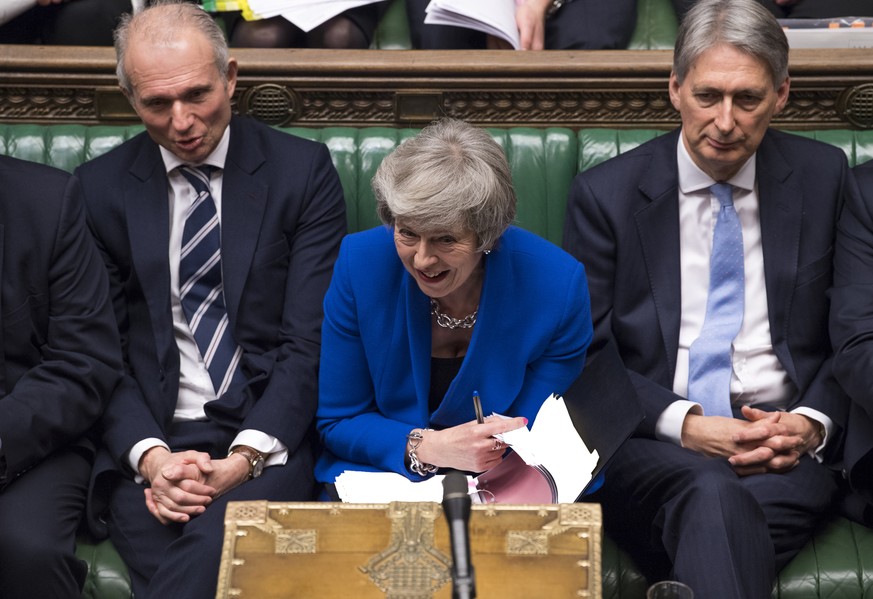 Britain&#039;s Prime Minister Theresa May reacts during a debate before a no-confidence vote raised by opposition Labour Party leader Jeremy Corbyn, in the House of Commons, London, Wednesday Jan. 16, ...