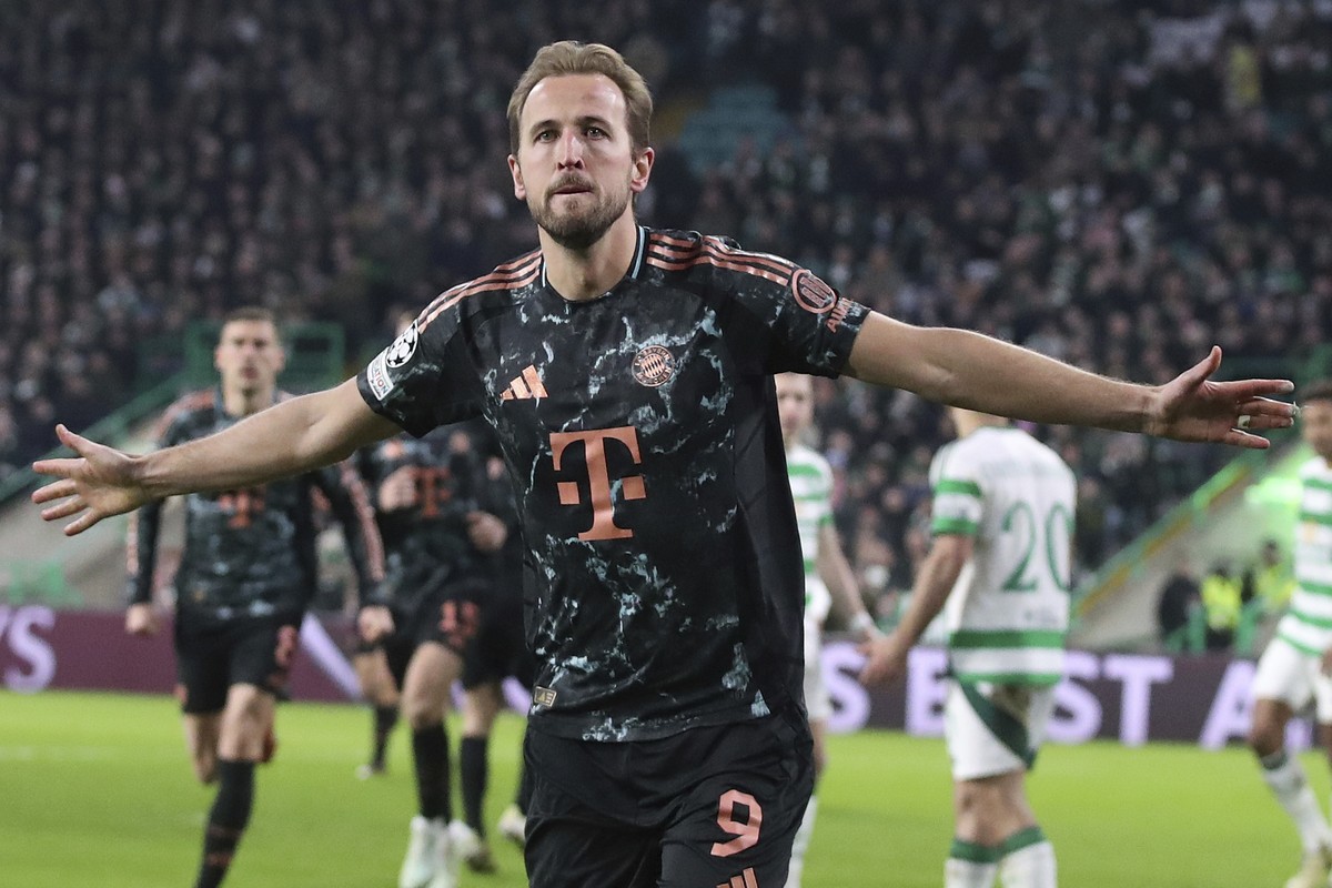 Bayern's Harry Kane celebrates after scoring his side's second goal during the Champions League play off first leg soccer match between Celtic Glasgow and Bayern Munich at the Celtic Park St ...
