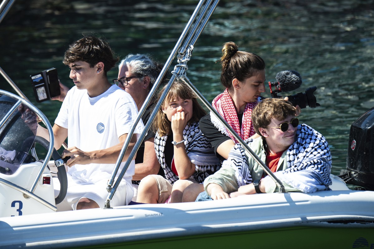Climate activist Greta Thunberg, center, waits to board the Madleen boat, before setting sail for Gaza along with activists of the Freedom Flotilla Coalition, departing from the Sicilian port of Catan ...