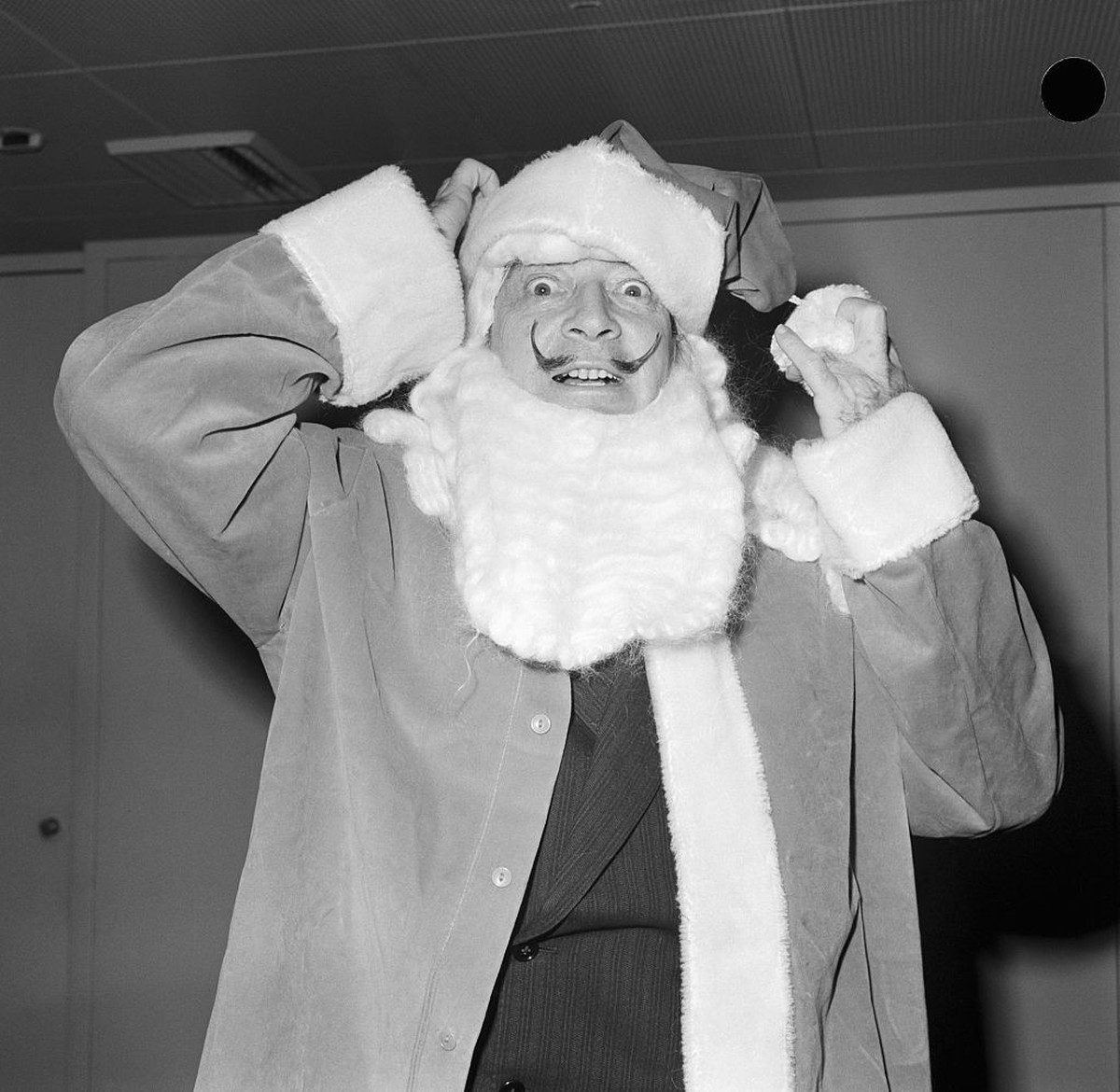 (Original Caption) 12/22/1961-Salvador Dali, Spanish painter, wearing Santa claus beard and a hat of his own creation called "Dali's Complex." Photograph.