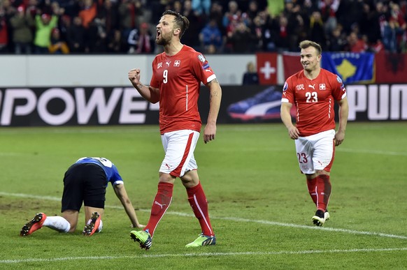 Switzerland&#039;s Haris Seferovic, center, and Xherdan Shaqiri celebrate their score to 3:0 during the UEFA EURO 2016 qualifying football match Switzerland against Estonia at the Swissporarena in Luc ...