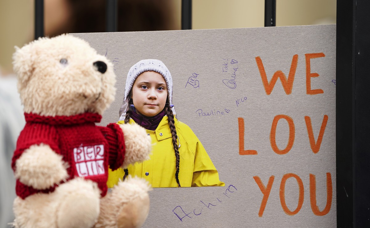 epa07470969 A cardboard with a picture of Swedish climate activist Greta Thunberg reading 'We love you' is placed next to a teddy bear on a 'Fridays for Future' demonstration again ...
