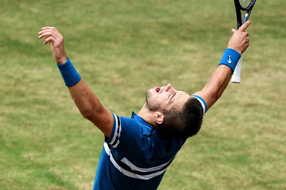 epa06835957 Borna Coric from Croatia celebrates after defeating Roger Federer from Switzerland in the final match of the ATP Tennis Tournament Gerry Weber Open in Halle (Westphalia), Germany, 24 June  ...
