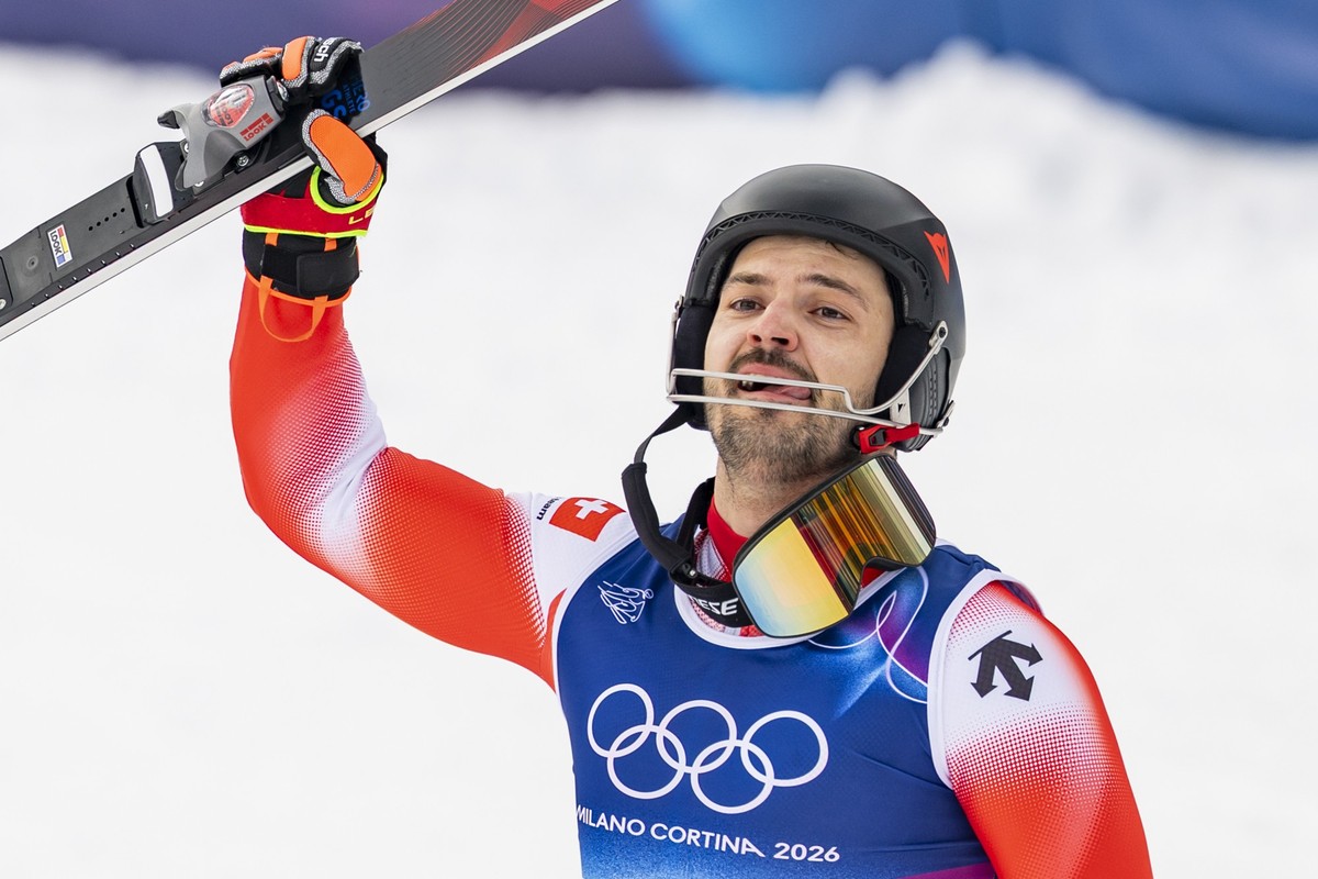 Switzerland's Loic Meillard celebrates as the winner in the finish area during the men's alpine skiing second run of the slalom race at the 2026 Olympic Winter Games at the Stelvio Ski centr ...