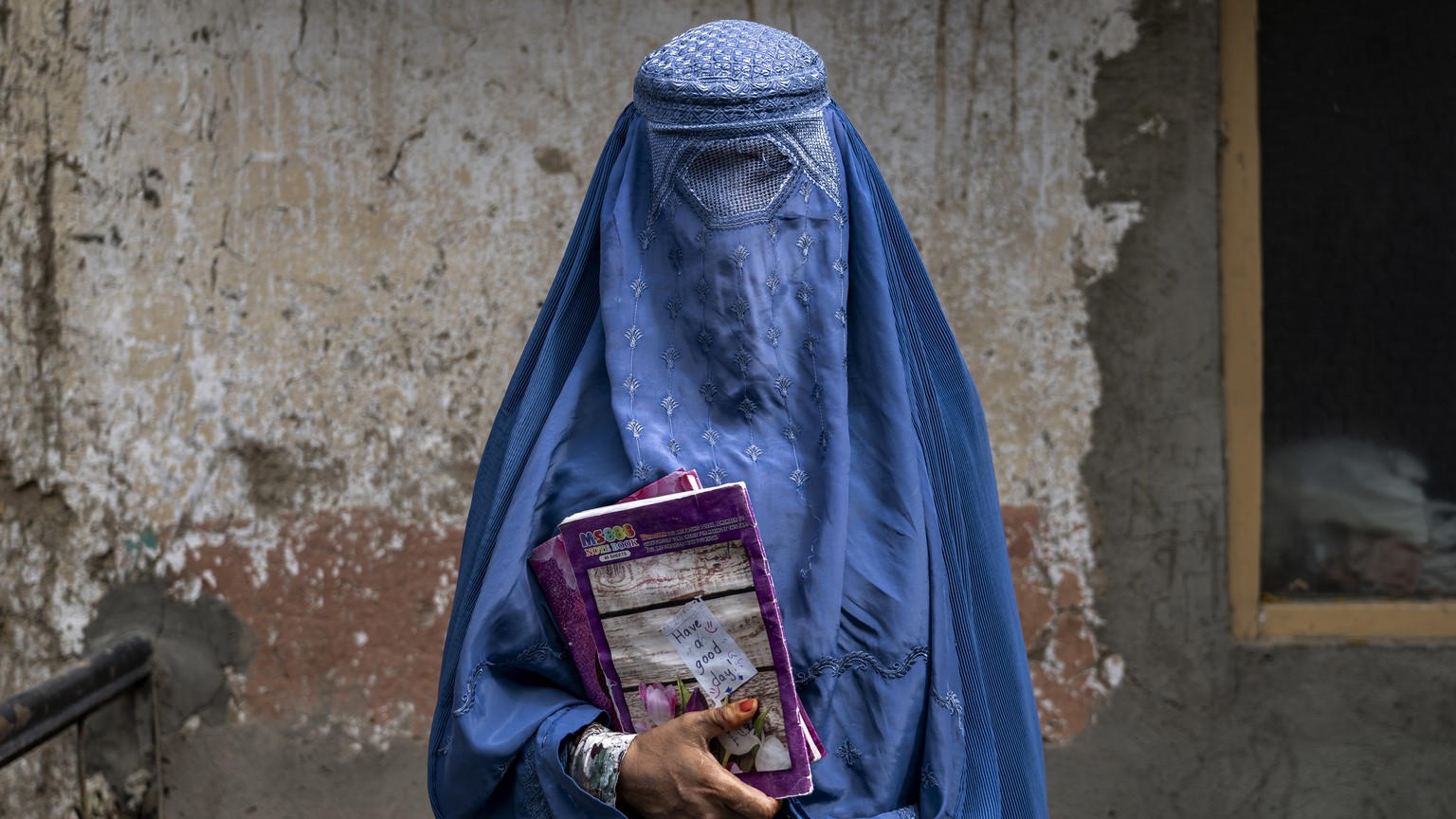 FILE- Arefeh 40-year-old, an Afghan woman leaves an underground school, in Kabul, Afghanistan, Saturday, July 30, 2022. Afghanistan&#039;s higher education minister Nida Mohammed Nadim on Saturday, Au ...