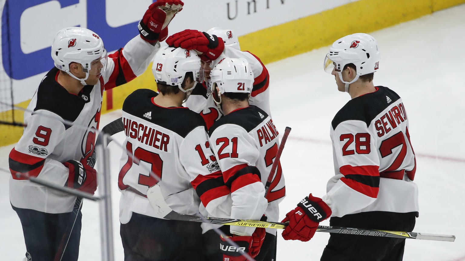 New Jersey Devils center Nico Hischier (13) celebrates with teammates after scoring against the Chicago Blackhawks during the second period of an NHL hockey game Sunday, Nov. 12, 2017, in Chicago. (AP ...