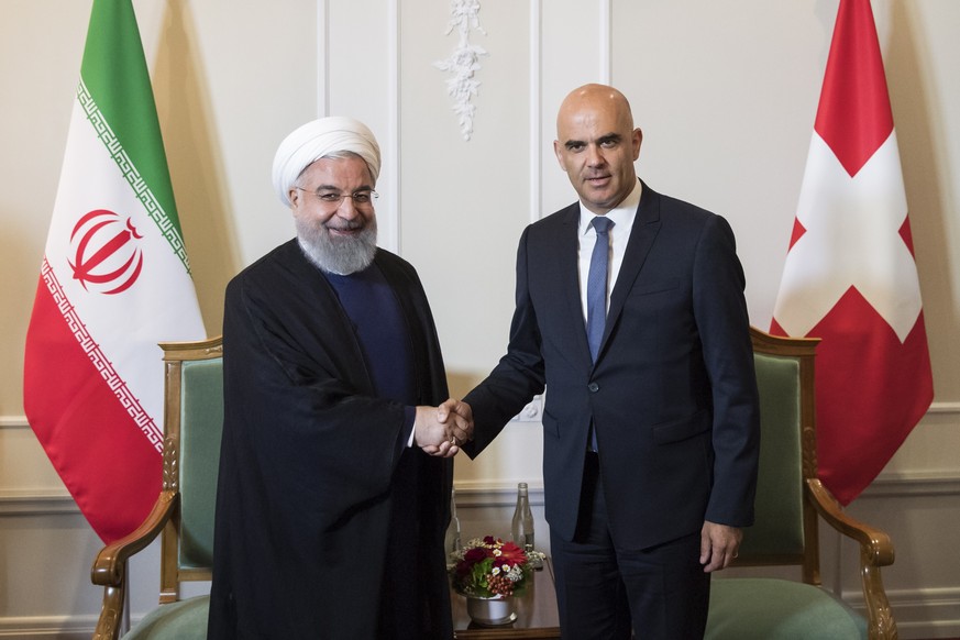 epa06859103 Swiss Federal President Alain Berset (R) and Iranian President Hassan Rohani (L) shake hands at the beginning of a meeting, during Rohani&#039;s official visit to Switzerland in Bern, Swit ...