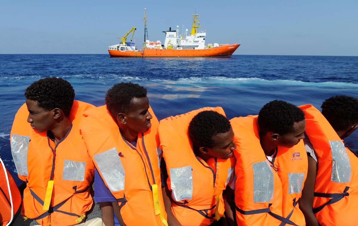 epa06947858 A handout photo made available by SOS Mediterranee on 13 August 2018 shows migrants being rescued by the NGO's rescue ship 'Aquarius' in the Mediterranean, 10 August 2018. T ...