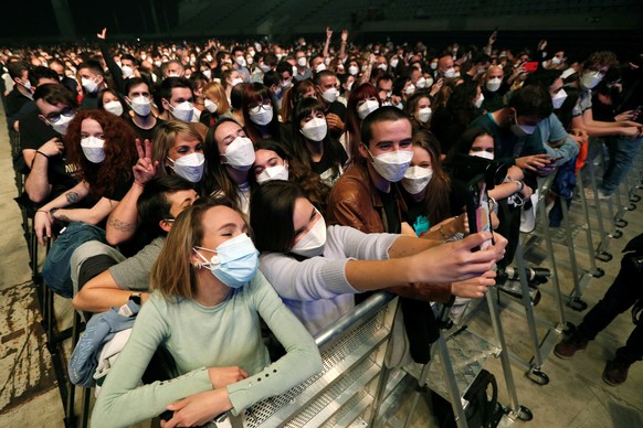 epa09101745 Members of the audience take a selfie as the Spanish band Love of Lesbian performs on stage in front of 5,000 people at the Palau Sant Jordi arena in Barcelona, Catalonia, Spain, 27 March  ...