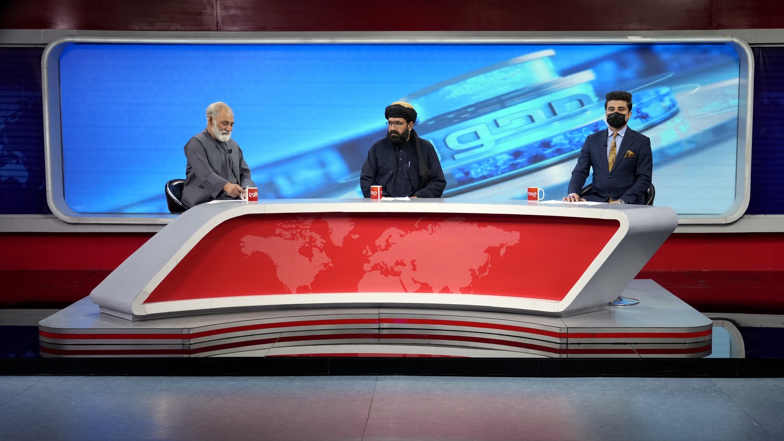 TV anchor Nesar Nabil wears a face mask to protest the Taliban&#039;s new order that female presenters cover their faces, as he reads the news on TOLOnews, in Kabul, Afghanistan, Sunday, May 22, 2022. ...