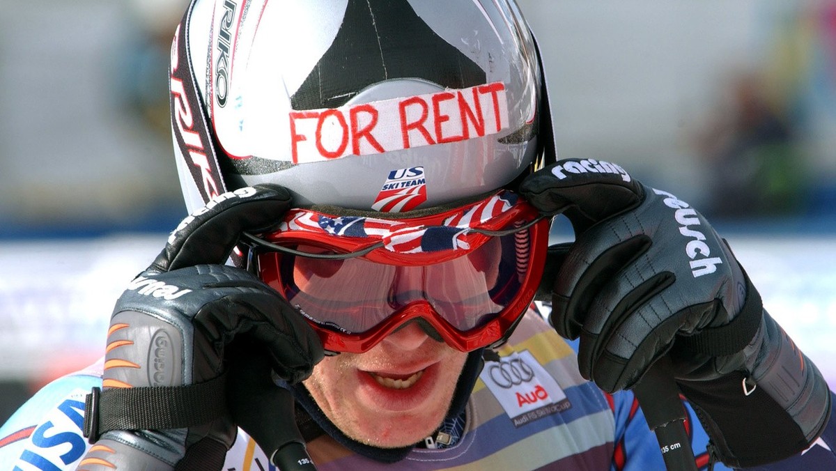 Bode Miller of the United States adjusts his goggles as he wears a helmet that reads "For rent" during a pause of practice for the World Cup men's downhill in Bormio, Italy, Friday, Jan ...